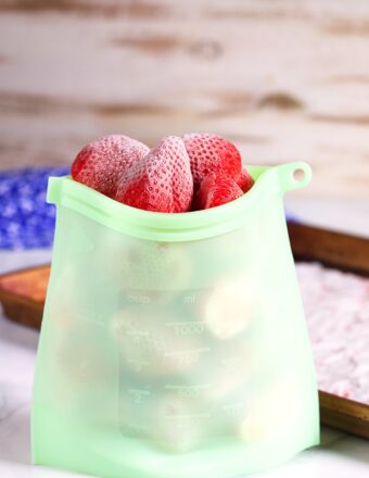 Frozen strawberries in a silicone freezer bag.