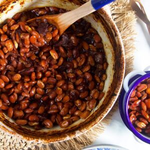 Overhead shot of boston baked beans in a blue and white casserole dish.