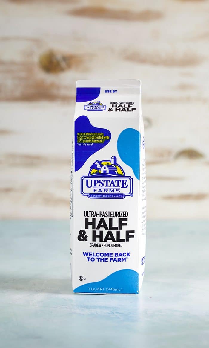 Carton of Half and Half on a blue background.