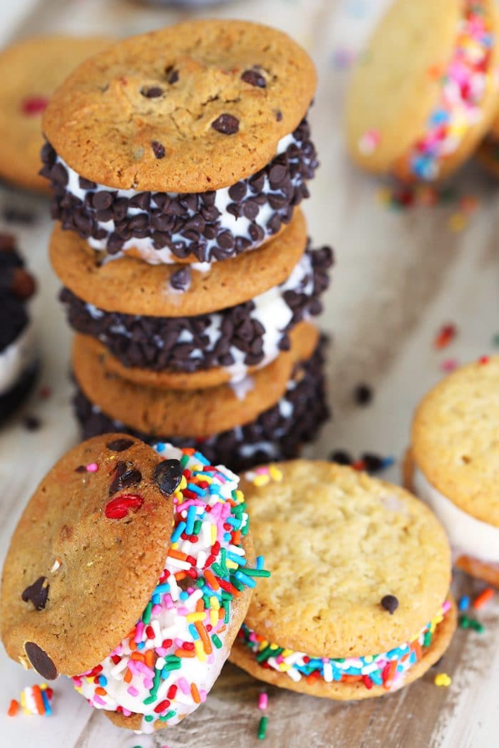 Stacked ice cream cookie sandwiches with chocolate chips and sprinkles.