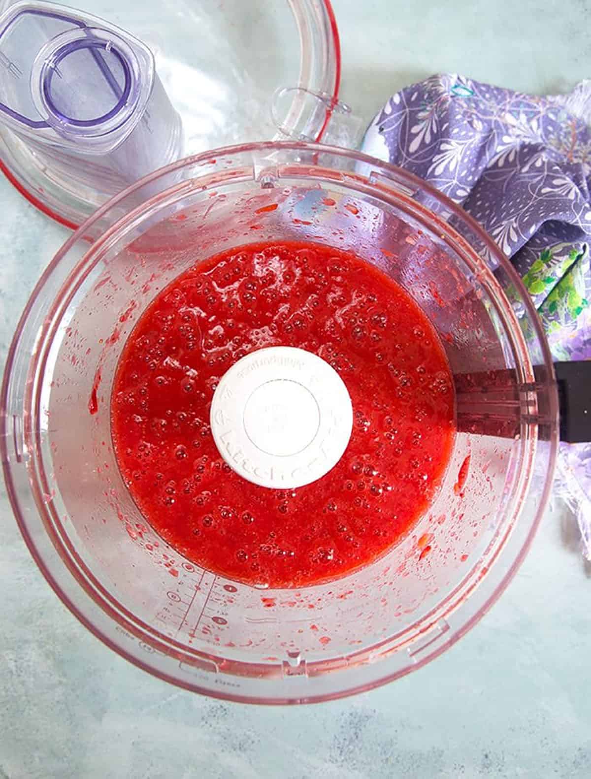 Strawberry puree in the bowl of a food processor