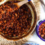 Overhead shot of boston baked beans in a blue and white casserole dish.
