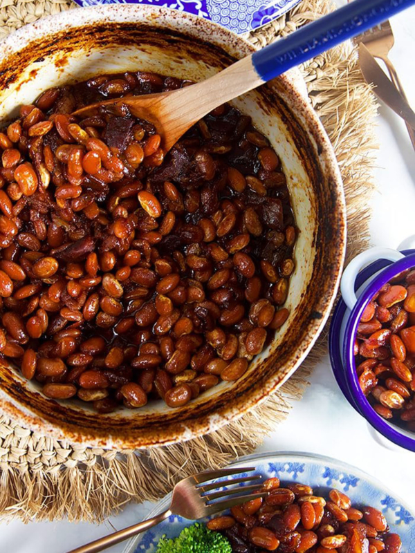 Overhead shot of boston baked beans in a blue and white casserole dish.