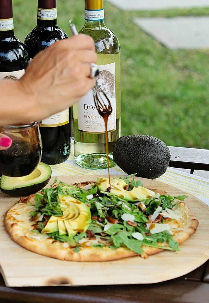 Balsamic Dressing being drizzled over a California Club Pizza