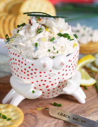 Crab dip in a crab bowl with crackers.