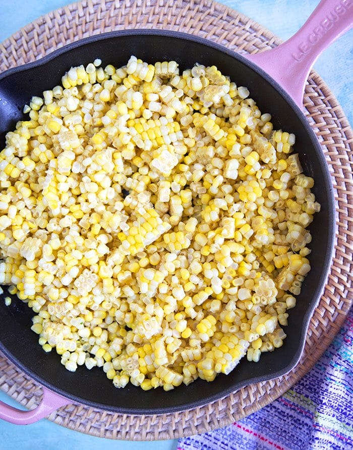 Sweet corn in a pink cast iron skillet