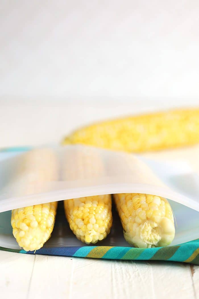 Corn on the cob in a silicone freezer bag.