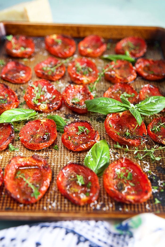 Side shot of oven roasted tomatoes on a baking sheet