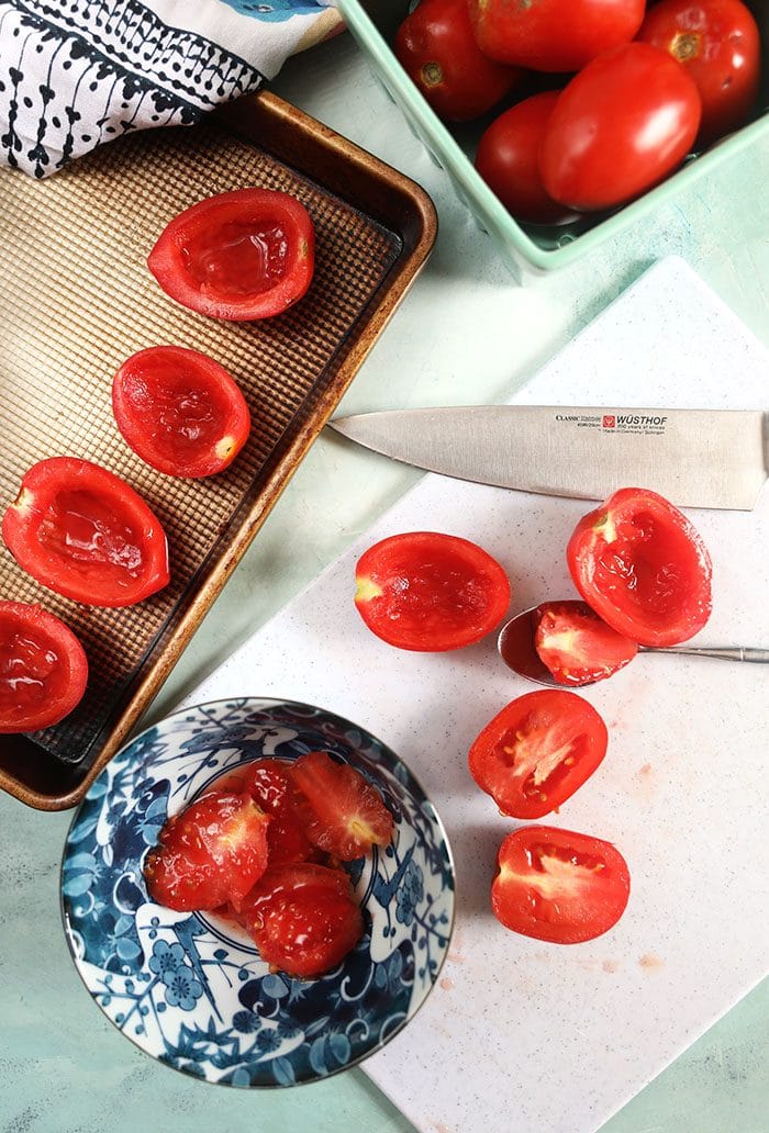 Plum tomatoes cut in half with the seeds removed.