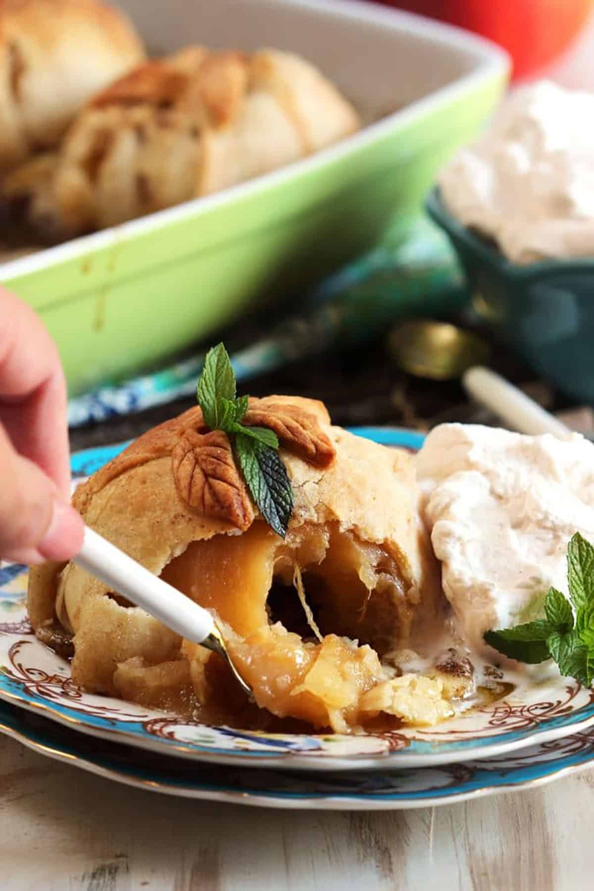 Apple Dumpling being cut into with a spoon.
