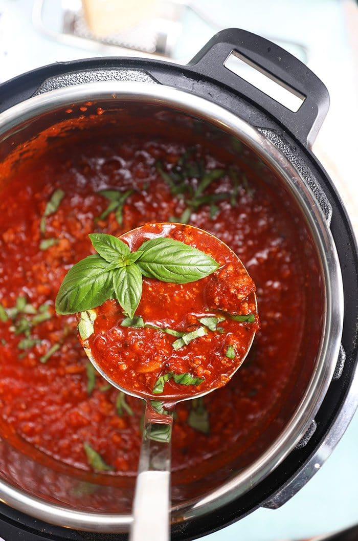 Instant Pot Bolognese Sauce with a ladle of sauce.