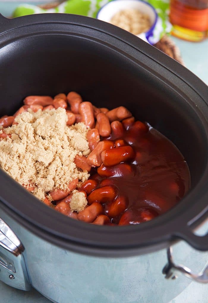 Slow Cooker with ingredients for BBQ Little Smokies.