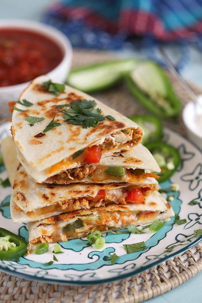 Stack of chicken quesadillas on a plate.