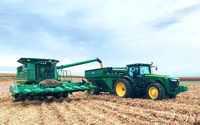 combine unloading corn into a tractor.