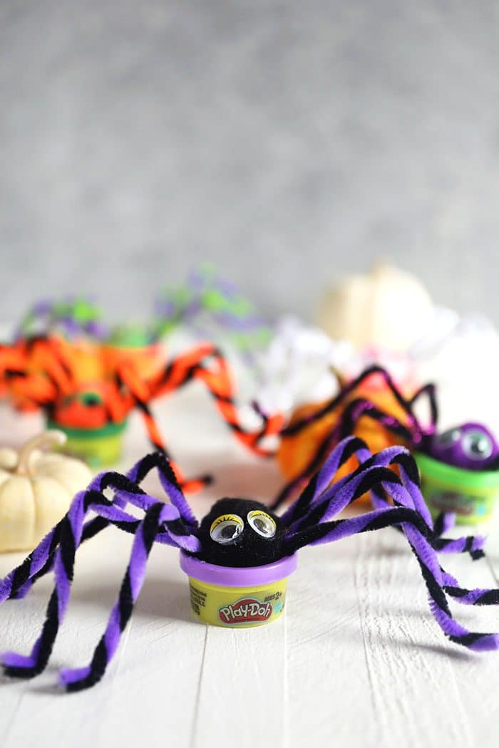 Play Doh spiders on a white background.