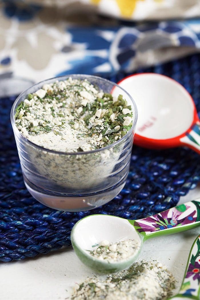 Ranch Seasoning in a glass dish on a blue placemat.
