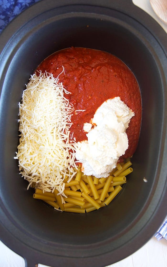 Ziti, sauce and cheese in a slow cooker.