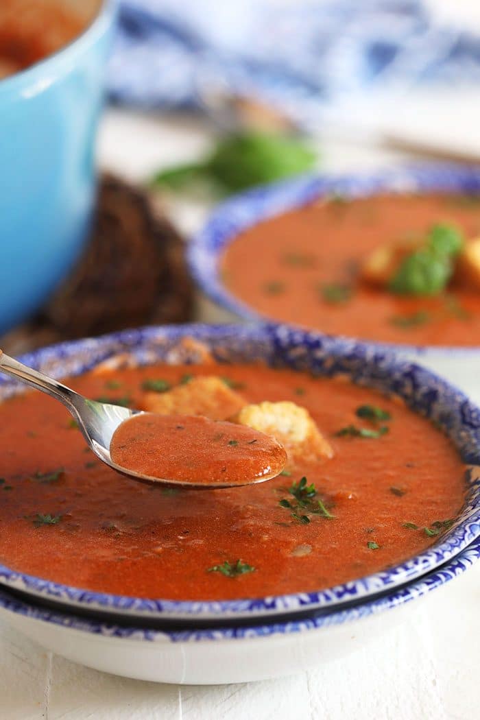 Tomato Basil Bisque with a spoon in it.