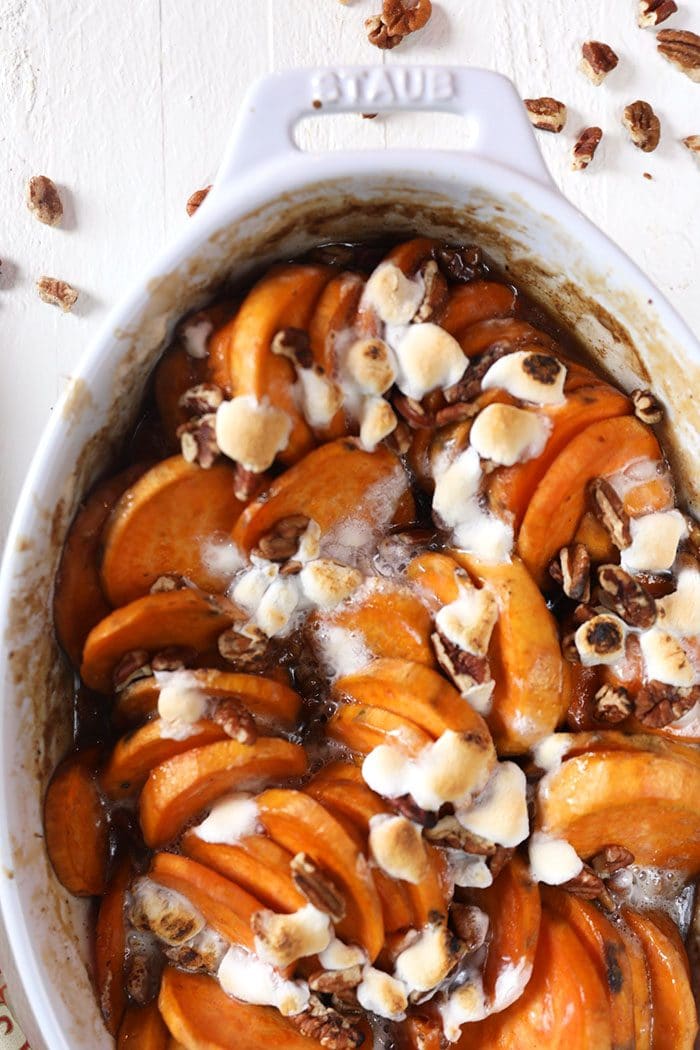 Candied yams in a white staub baking dish.