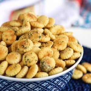 Ranch oyster crackers in a blue and white bowl on a blue background.