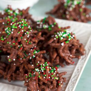 Chocolate haystack cookies on a white square plate.