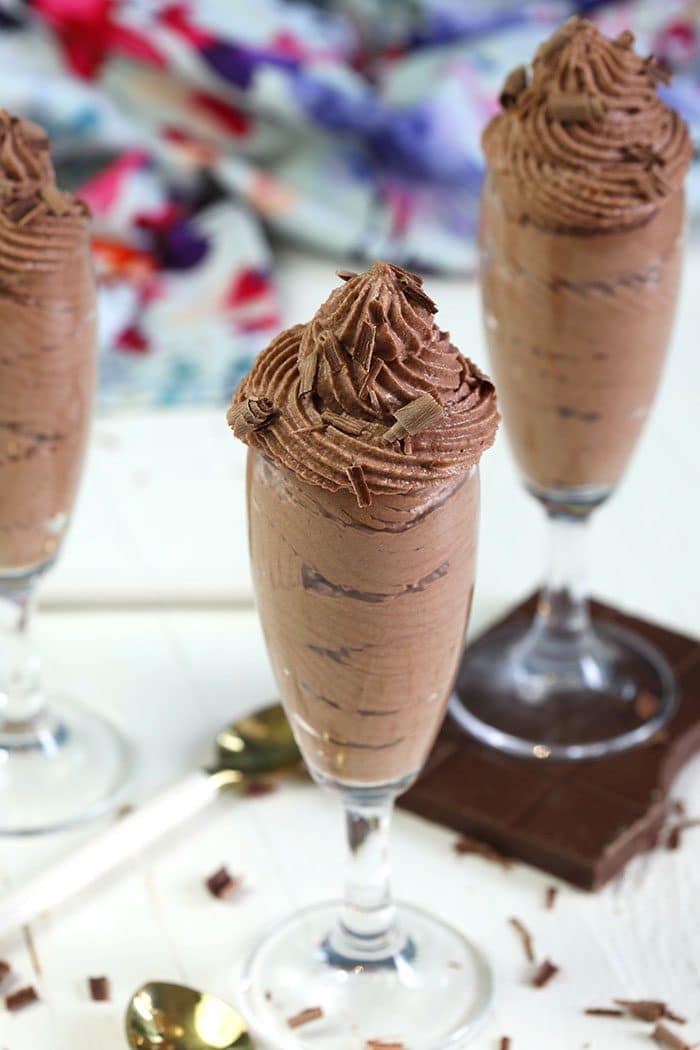Chocolate mousse in a champagne flute with chocolate shavings on top.