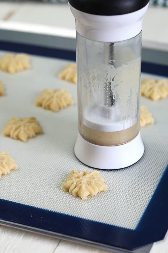 Cookie press making spritz cookies.