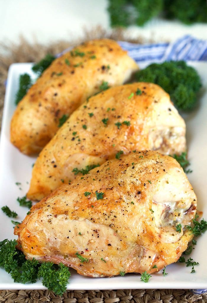 Chicken breast on a white platter.