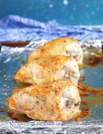 Roasted chicken breast on a baking sheet.