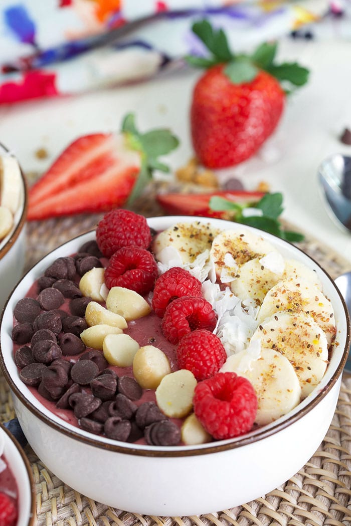 Acai bowl with raspberries, macadamia nuts and chocolate.