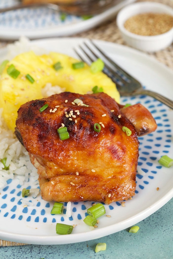 Huli Huli Chicken on a white plate with a pineapple slice.