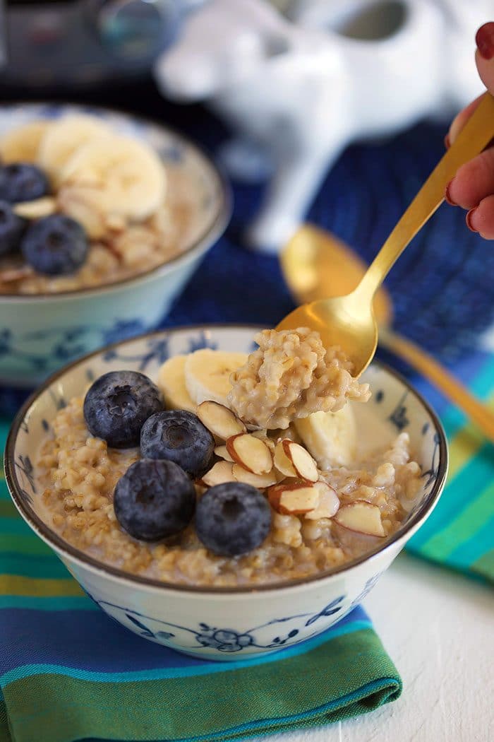 oatmeal in a blue and white bowl with a gold fork.