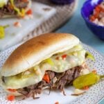 Shredded Italian Beef on a long roll with giardiniera and melted cheese.