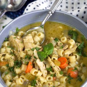 Pesto Chicken Noodle Soup in a gray bowl.