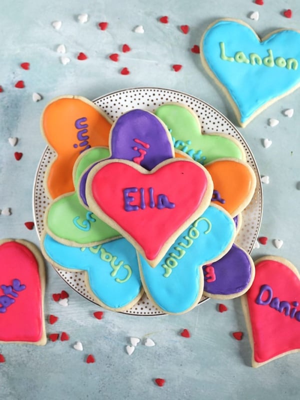 Overhead shot of valentine sugar cookies on a white plate.
