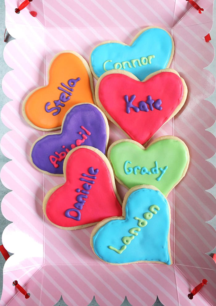 Overhead shot of Valentine cookies on a pink tray.