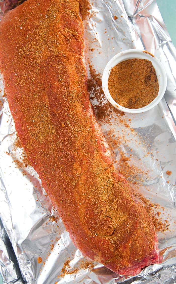 Rack of ribs with bbq rub on them.
