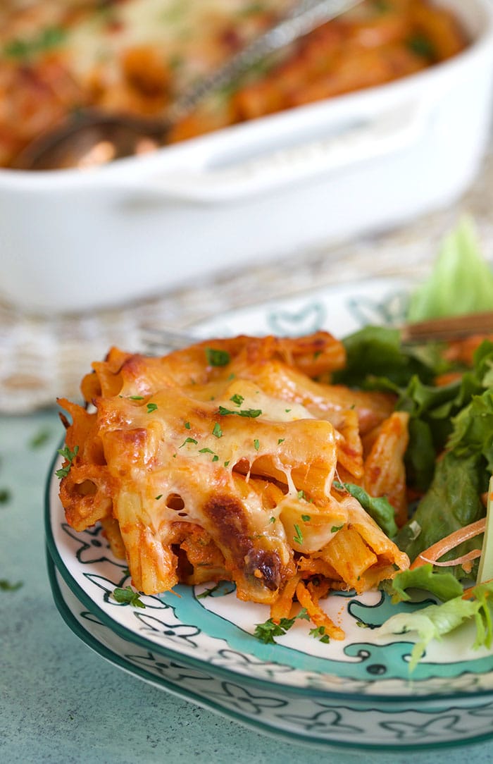 Baked Rigatoni on a plate with salad.