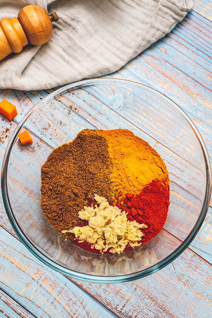 Spices for butter chicken in a glass bowl.
