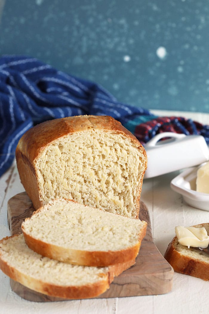 Homemade white bread sliced on a bread board.