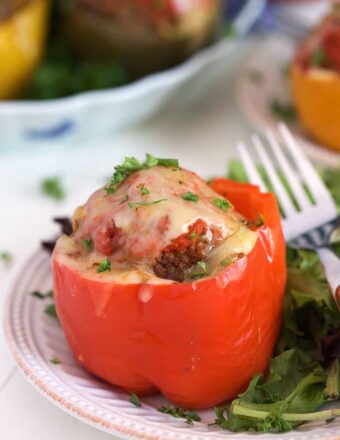 Stuffed red bell pepper on a plate.