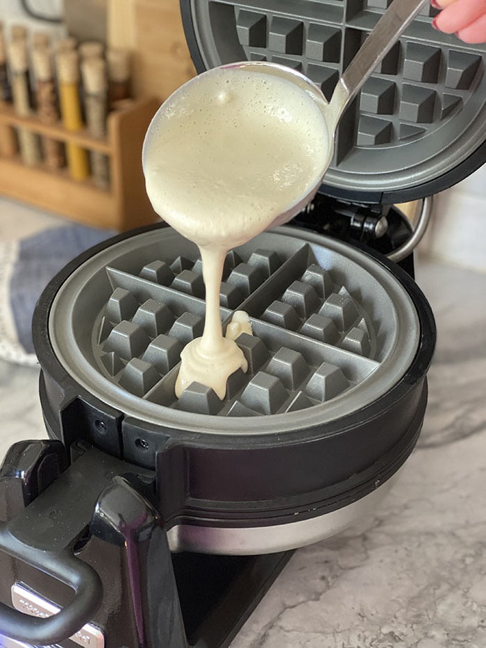 Batter being poured onto waffle iron.