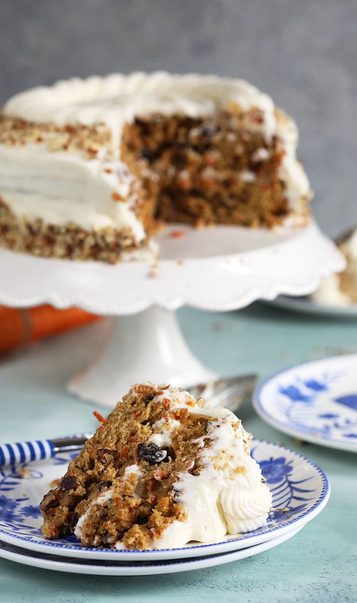 Carrot Cake Layer cake with a slice on a blue and white plate.