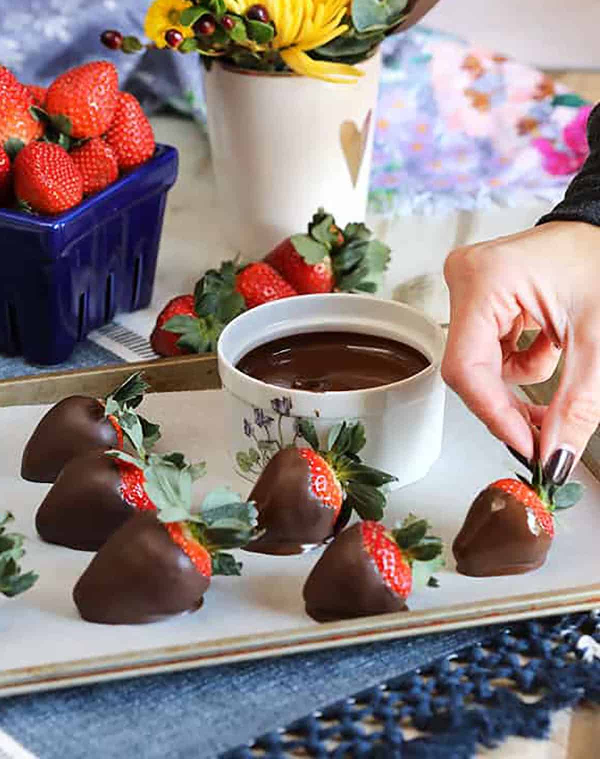 Chocolate dipped strawberries on a baking sheet lined with parchment