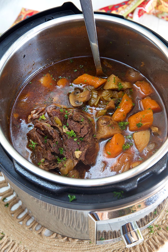 Overhead shot of pot roast and vegetables in an Instant Pot.