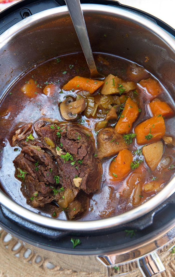 Close up of pot roast and vegetables in an Instant Pot.