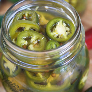 Pickled jalapeños in a jar.