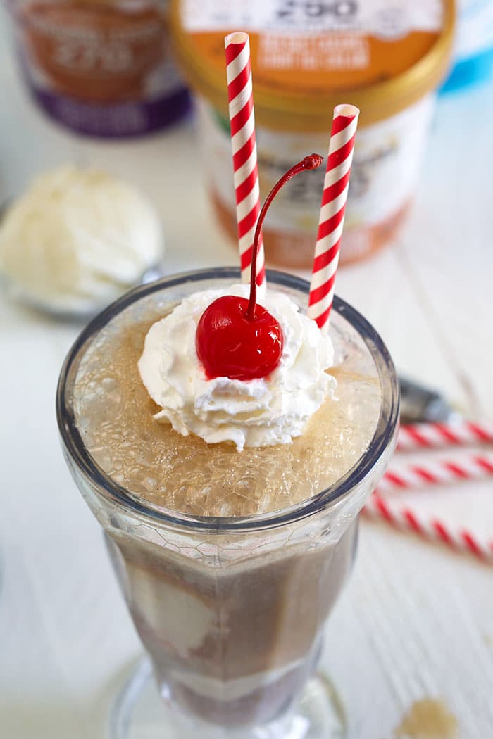 Close up of root beer float on a white background.