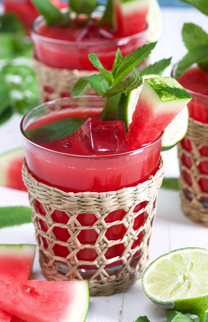 Close up of watermelon water in a seagrass glass.