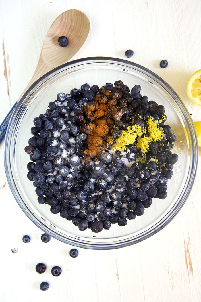 ingredients for blueberry dump cake in a glass bowl.